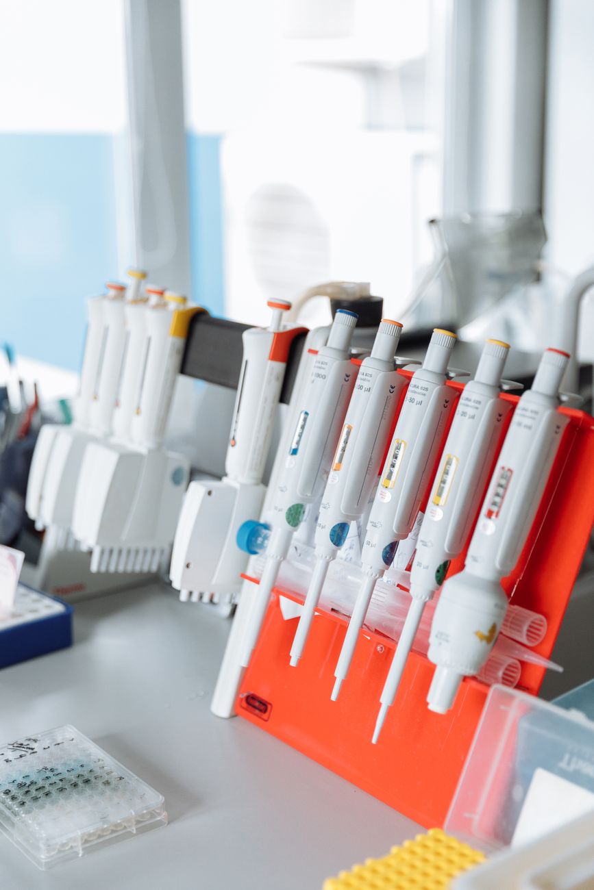 Researchers working in a bright, modern laboratory with advanced scientific equipment